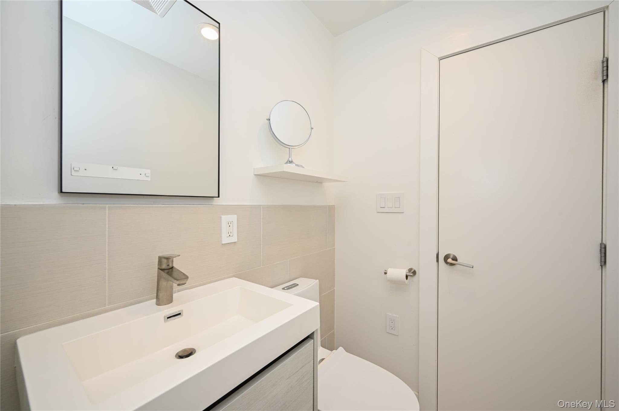 69-25 215th Street, Unit A Queens, NY 11364 - Photo 12 of 17 a bathroom with a sink a toilet and shower