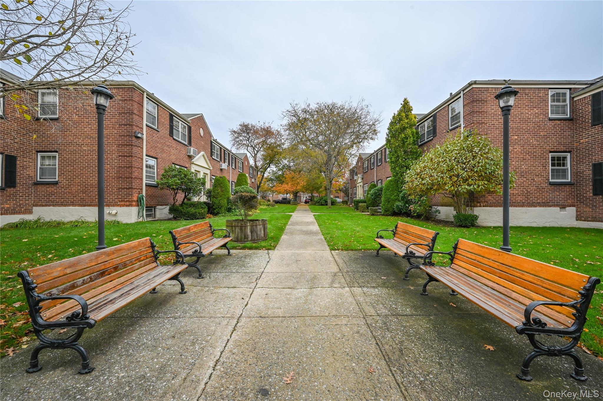 69-25 215th Street, Unit A Queens, NY 11364 - Photo 13 of 17 a backyard of a house with barbeque oven table and chairs