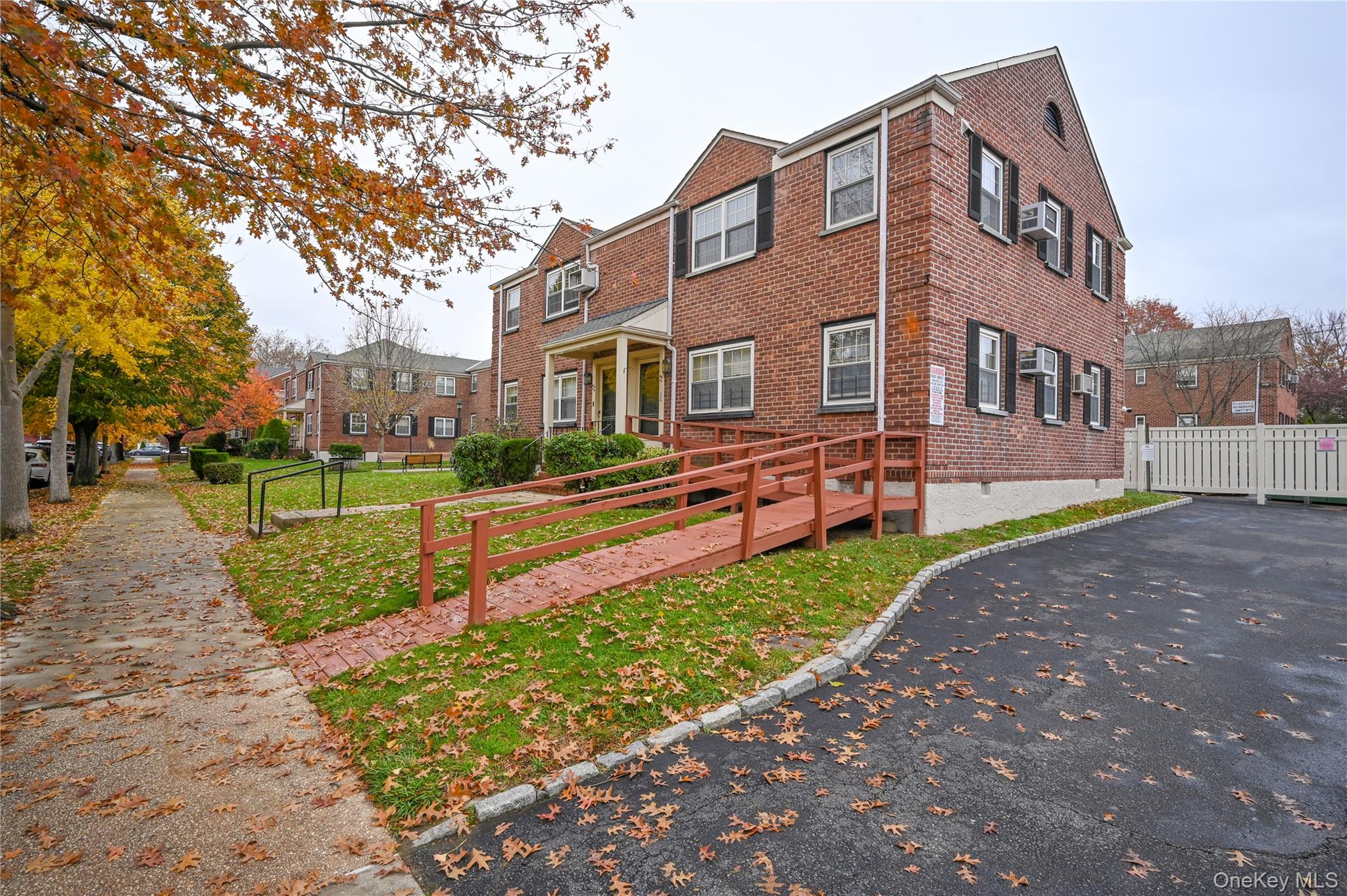69-25 215th Street, Unit A Queens, NY 11364 - Photo 14 of 17 a front view of a house with a yard and garden