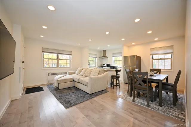 a living room with furniture wooden floor and a flat screen tv