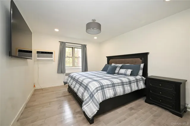 a bedroom with a large bed and a window