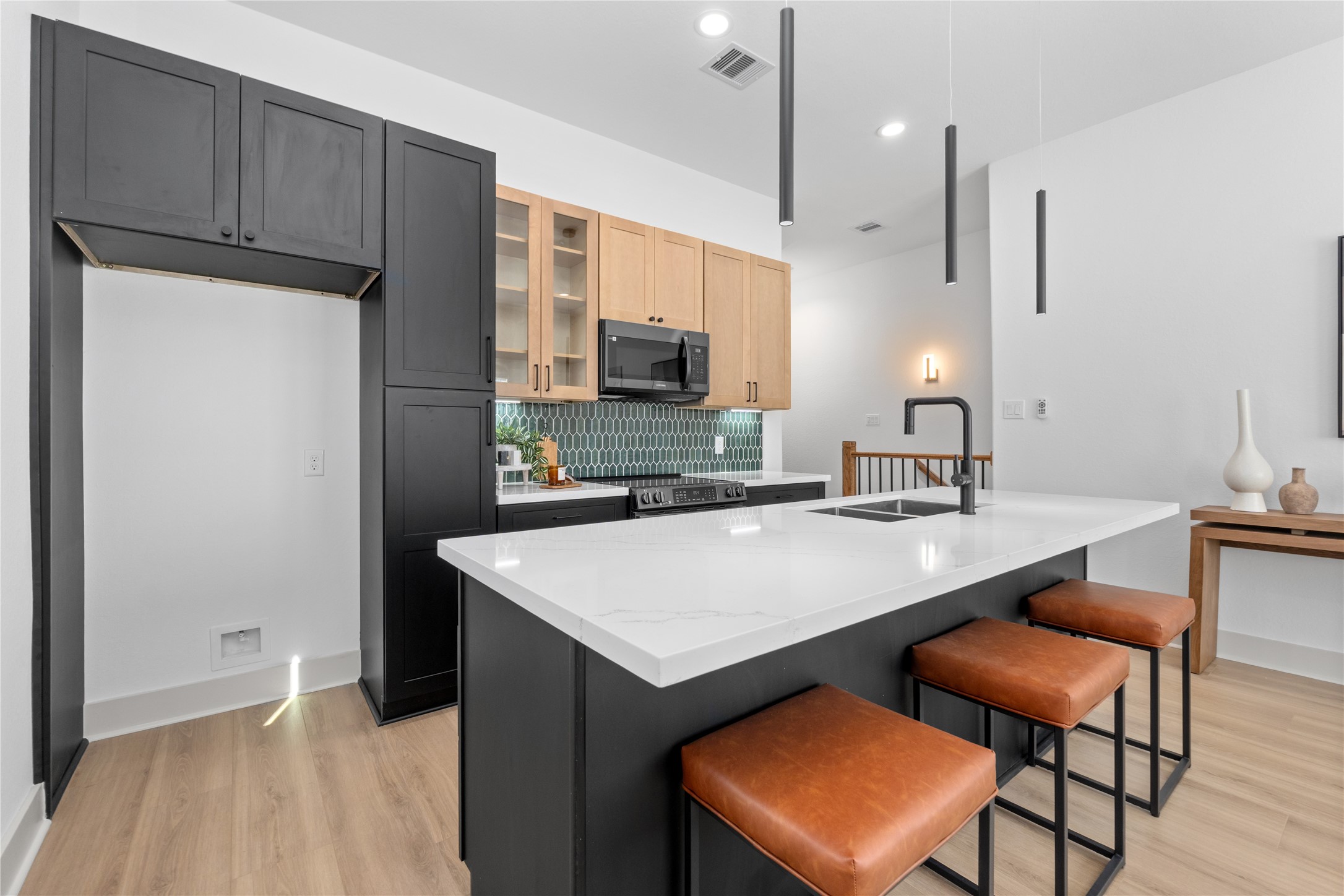 9819 Turnbow Street, Unit CD Houston, TX 77029 - Photo 12 of 32 a kitchen with a sink a counter top space and cabinets