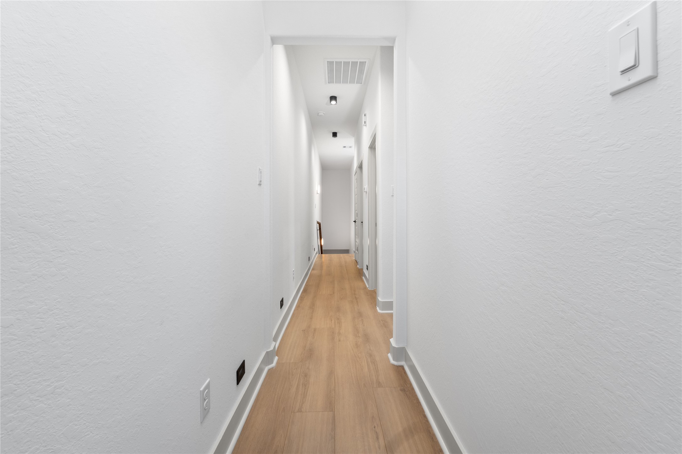 9819 Turnbow Street, Unit CD Houston, TX 77029 - Photo 15 of 32 a view of a hallway with wooden floor