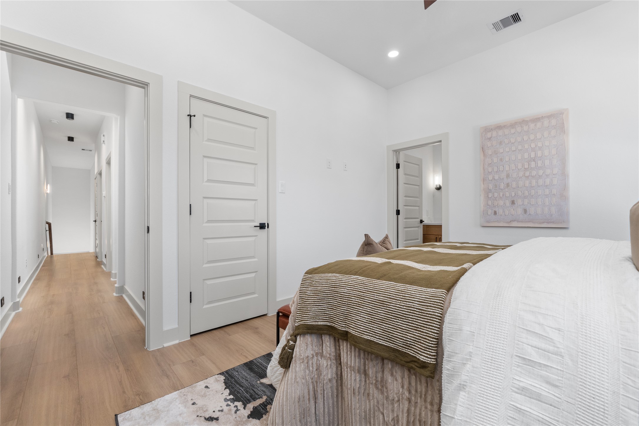9819 Turnbow Street, Unit CD Houston, TX 77029 - Photo 17 of 32 a spacious bedroom with a bed and a dresser