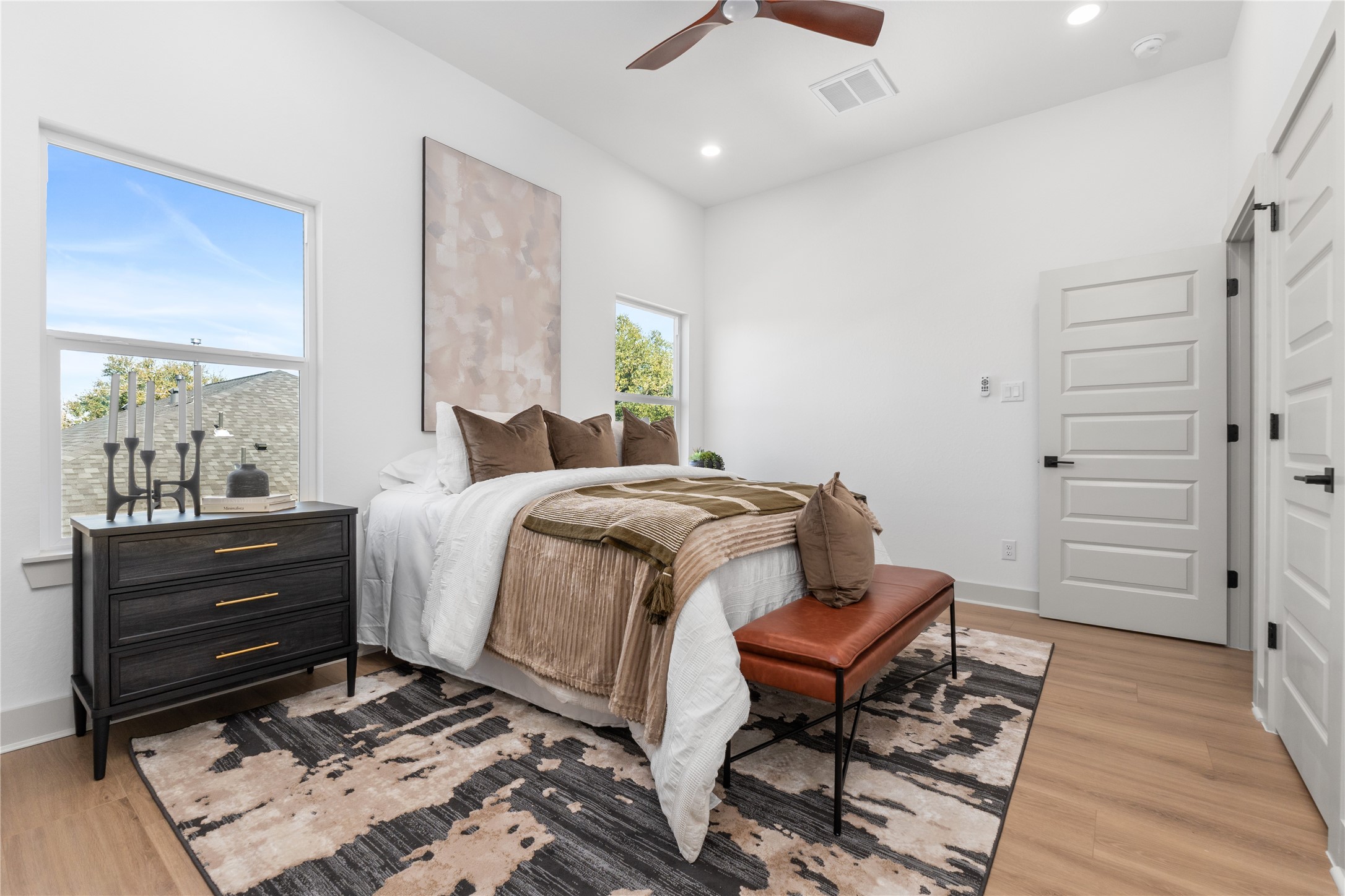 9819 Turnbow Street, Unit CD Houston, TX 77029 - Photo 18 of 32 a bedroom with a bed and wooden floor