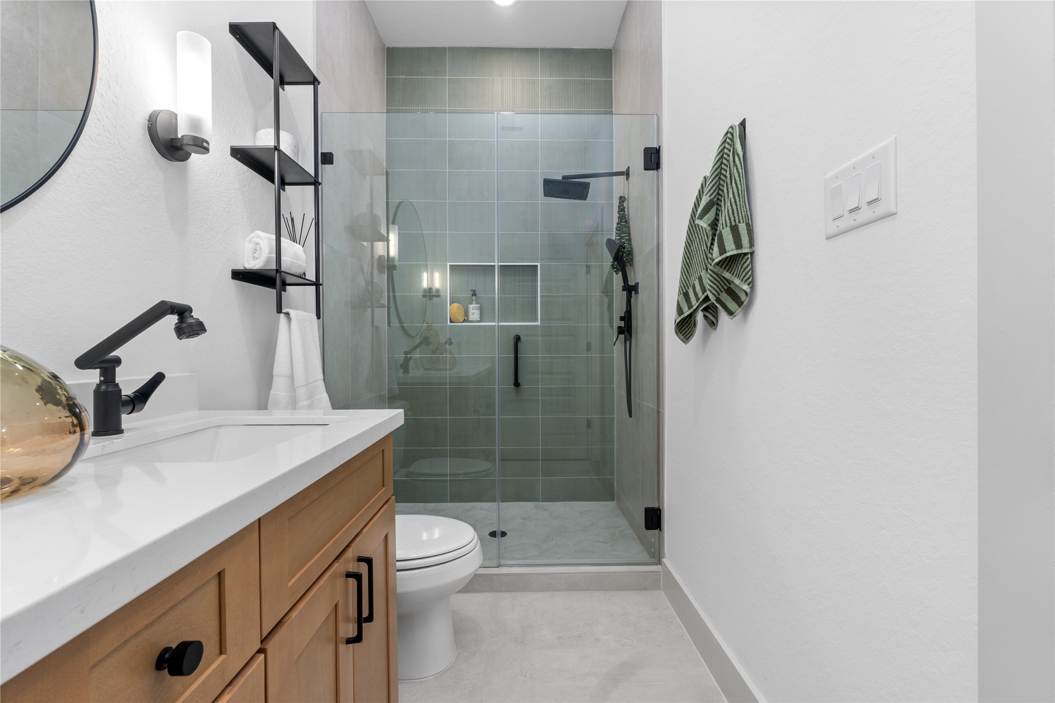 9819 Turnbow Street, Unit CD Houston, TX 77029 - Photo 23 of 32 a bathroom with a granite countertop sink a toilet and shower