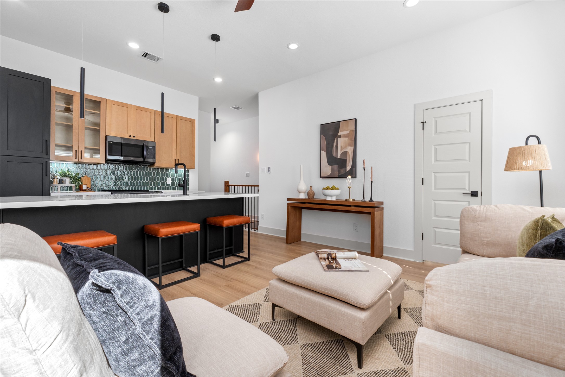 9819 Turnbow Street, Unit CD Houston, TX 77029 - Photo 7 of 32 a living room with furniture a flat screen tv and kitchen area