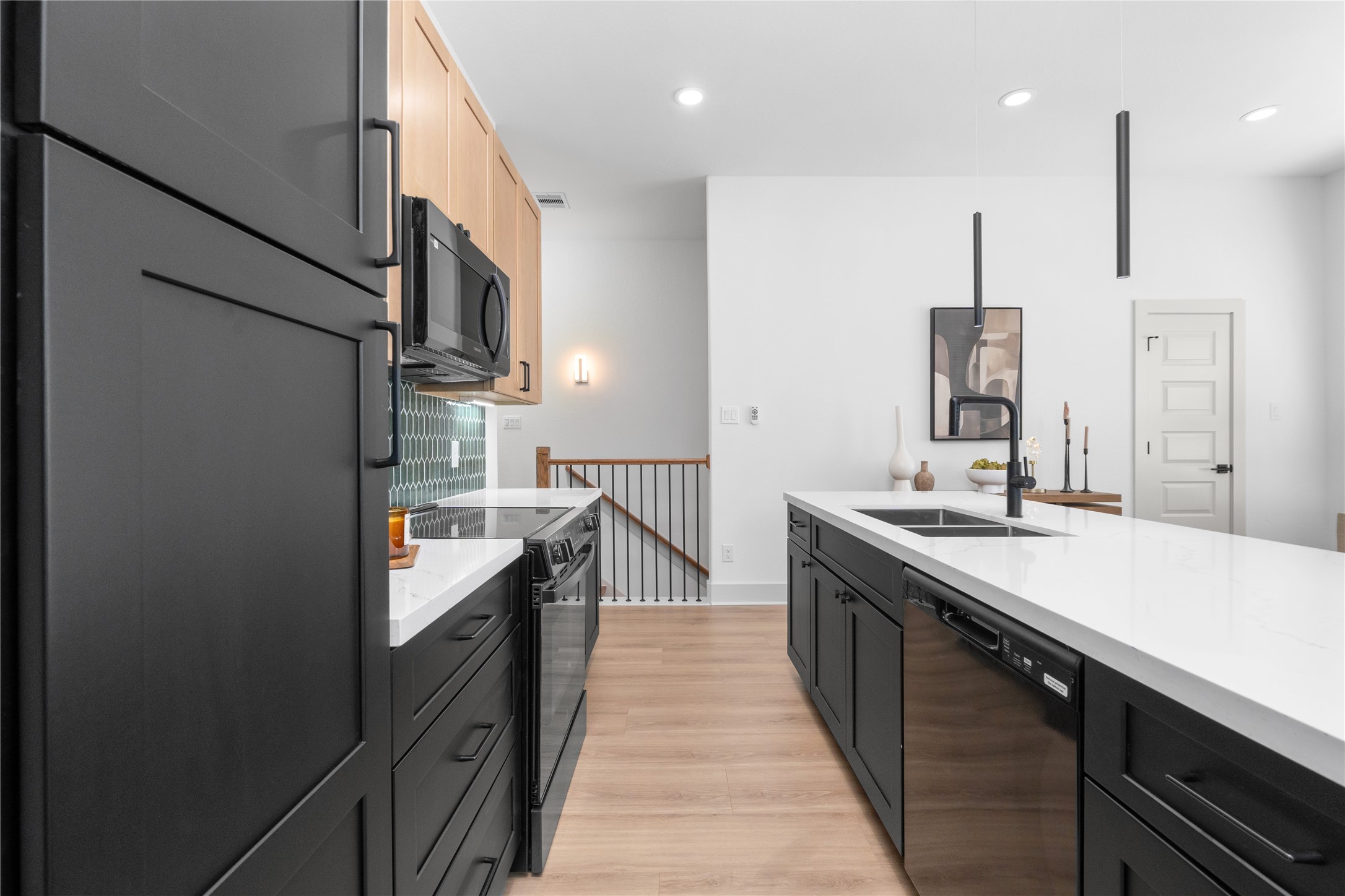 9819 Turnbow Street, Unit CD Houston, TX 77029 - Photo 10 of 32 a kitchen with stainless steel appliances granite countertop a sink a stove and a refrigerator