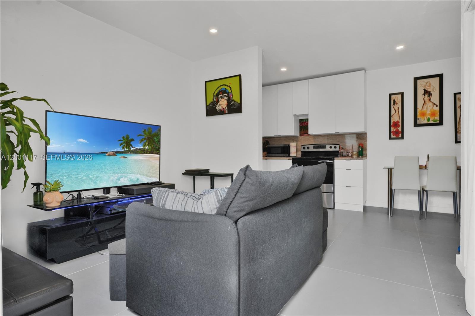 11775 Southwest 223rd Street Miami, FL 33170 - Photo 17 of 42 a living room with furniture and a flat screen tv