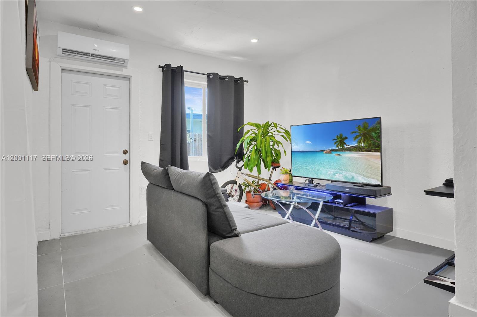 11775 Southwest 223rd Street Miami, FL 33170 - Photo 18 of 42 a living room with furniture and a flat screen tv