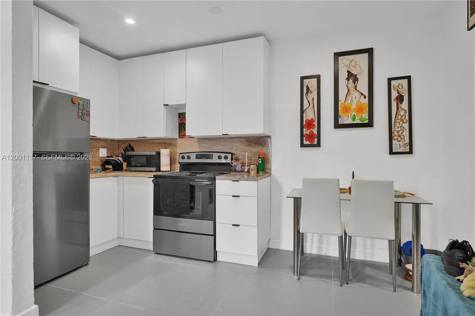 11775 Southwest 223rd Street Miami, FL 33170 - Photo 20 of 42 a kitchen with stainless steel appliances a refrigerator stove and table