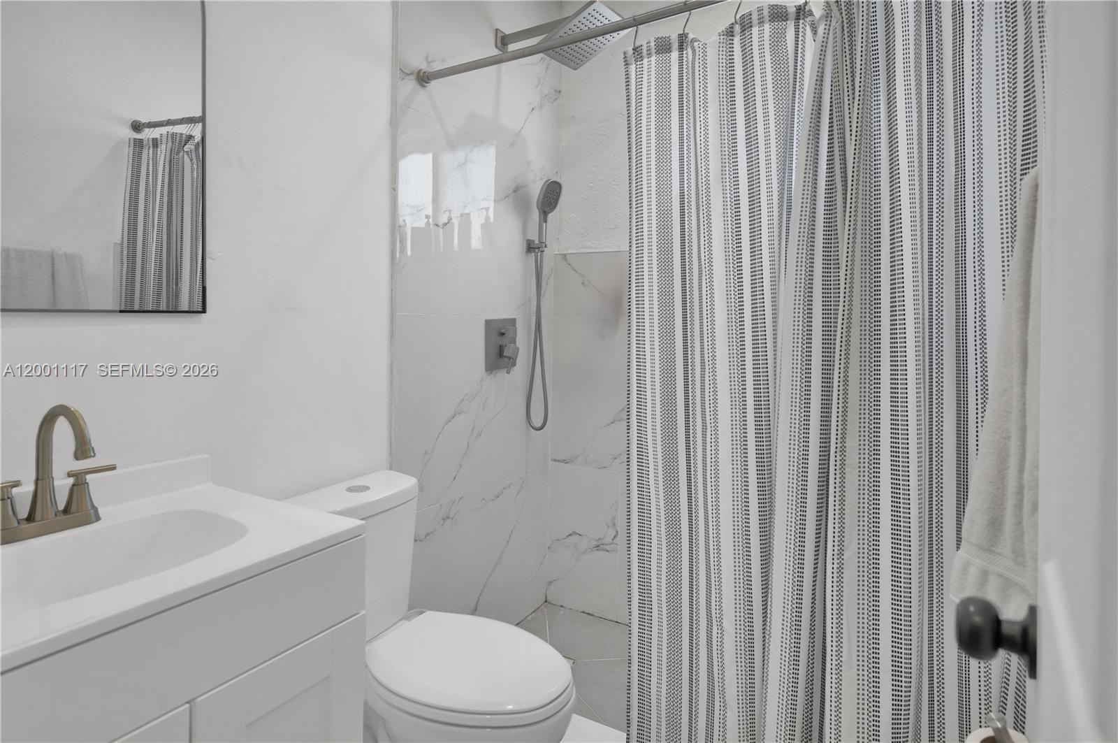 11775 Southwest 223rd Street Miami, FL 33170 - Photo 22 of 42 a bathroom with a toilet a sink and shower