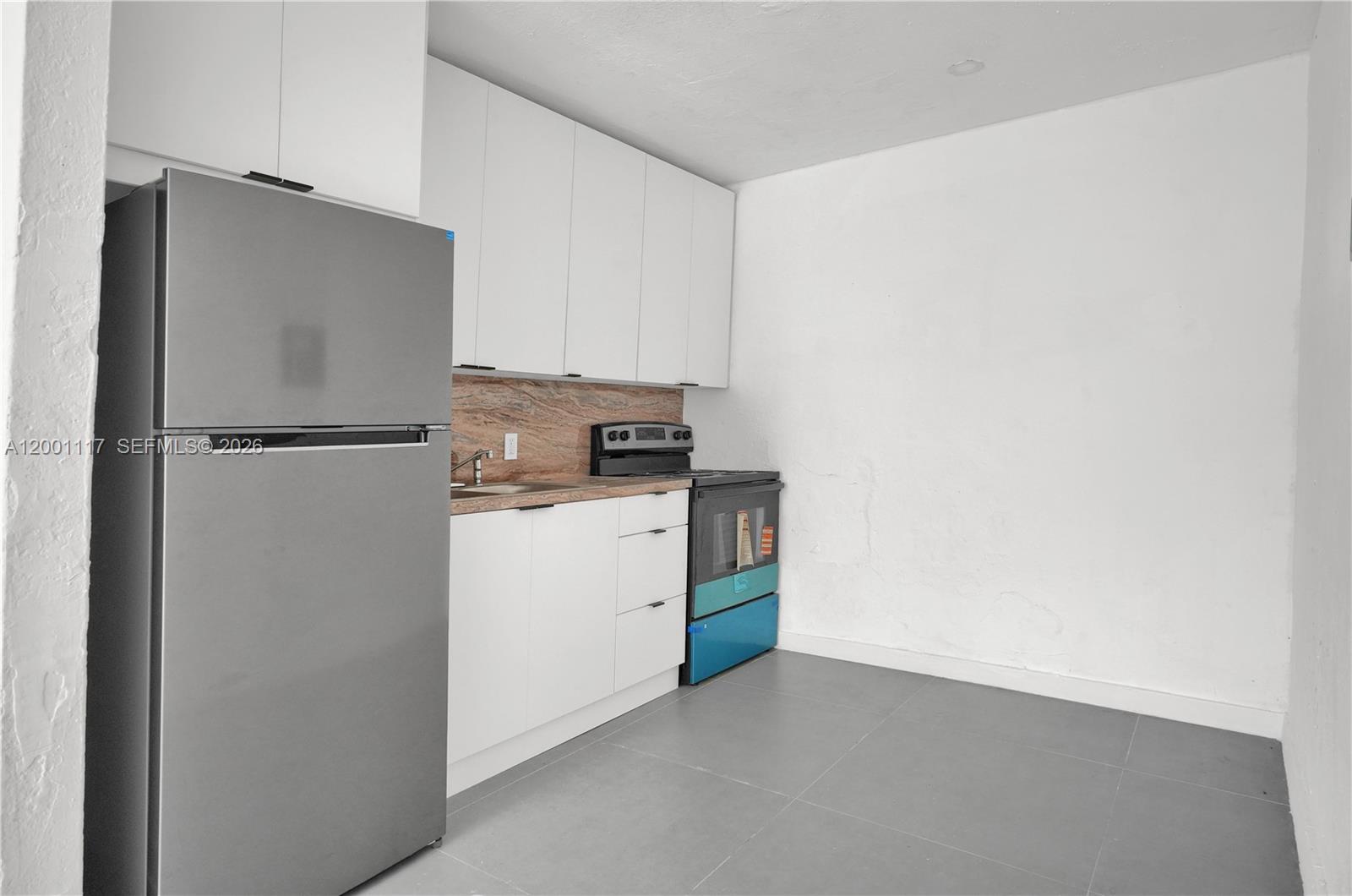 11775 Southwest 223rd Street Miami, FL 33170 - Photo 28 of 42 a kitchen with a refrigerator and a stove