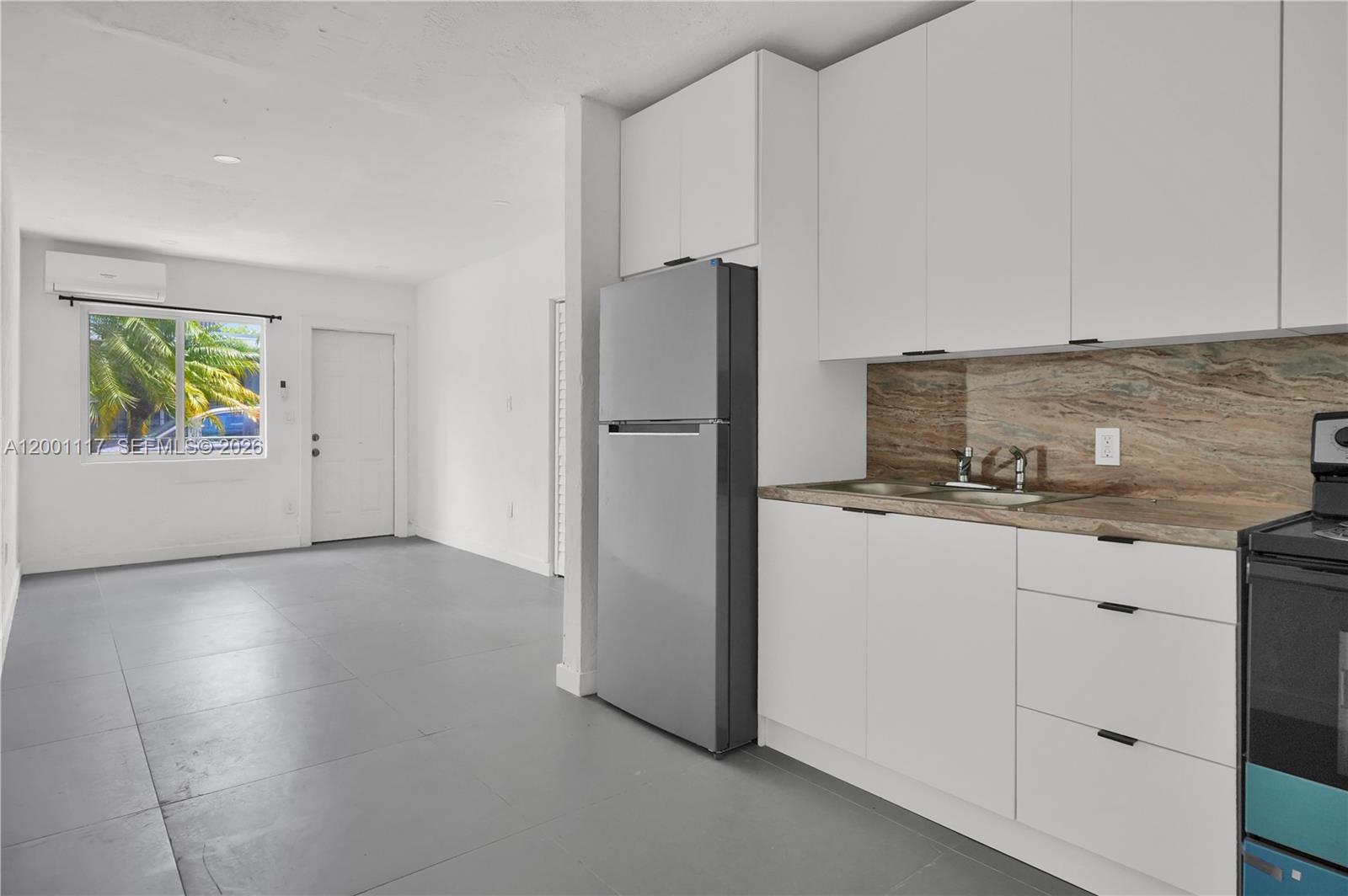11775 Southwest 223rd Street Miami, FL 33170 - Photo 30 of 42 a kitchen with granite countertop cabinets and refrigerator