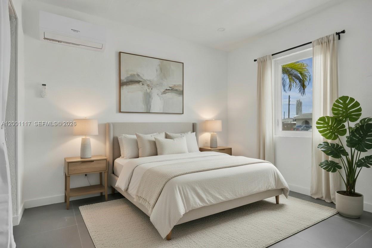 11775 Southwest 223rd Street Miami, FL 33170 - Photo 35 of 42 a bedroom with a large bed and a potted plant