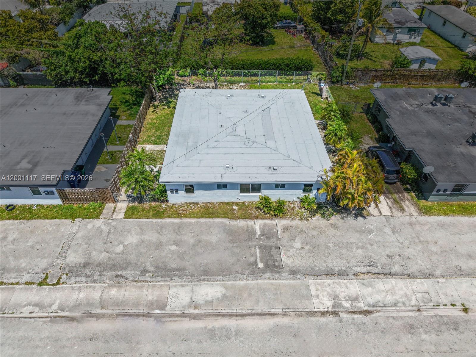 11775 Southwest 223rd Street Miami, FL 33170 - Photo 4 of 42 an aerial view of a house with a yard and a large parking space