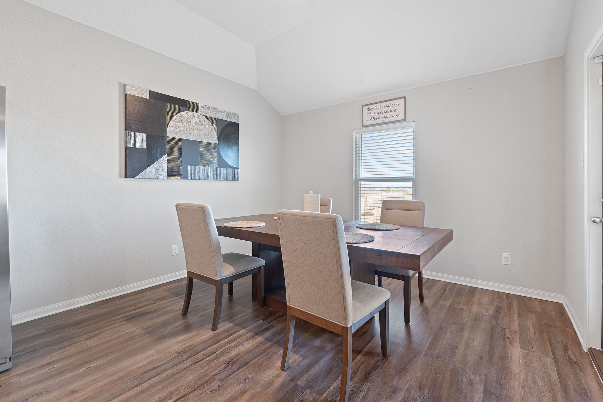 19212 Andrew Jackson Street Manor, TX 78653 - Photo 12 of 35 a view of a dining room with furniture and wooden floor