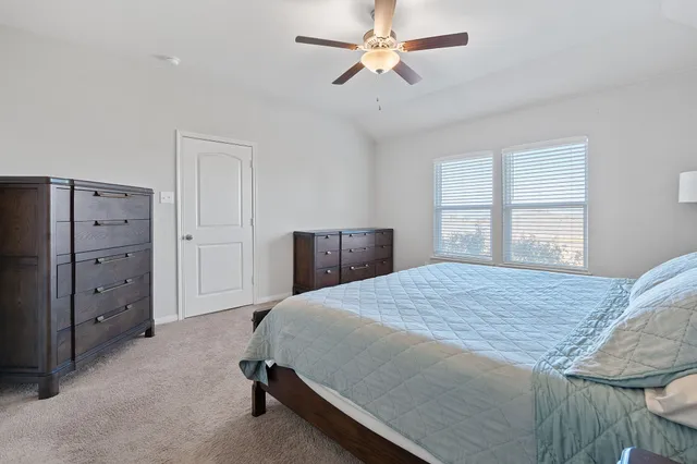 a bedroom with a bed and a dresser