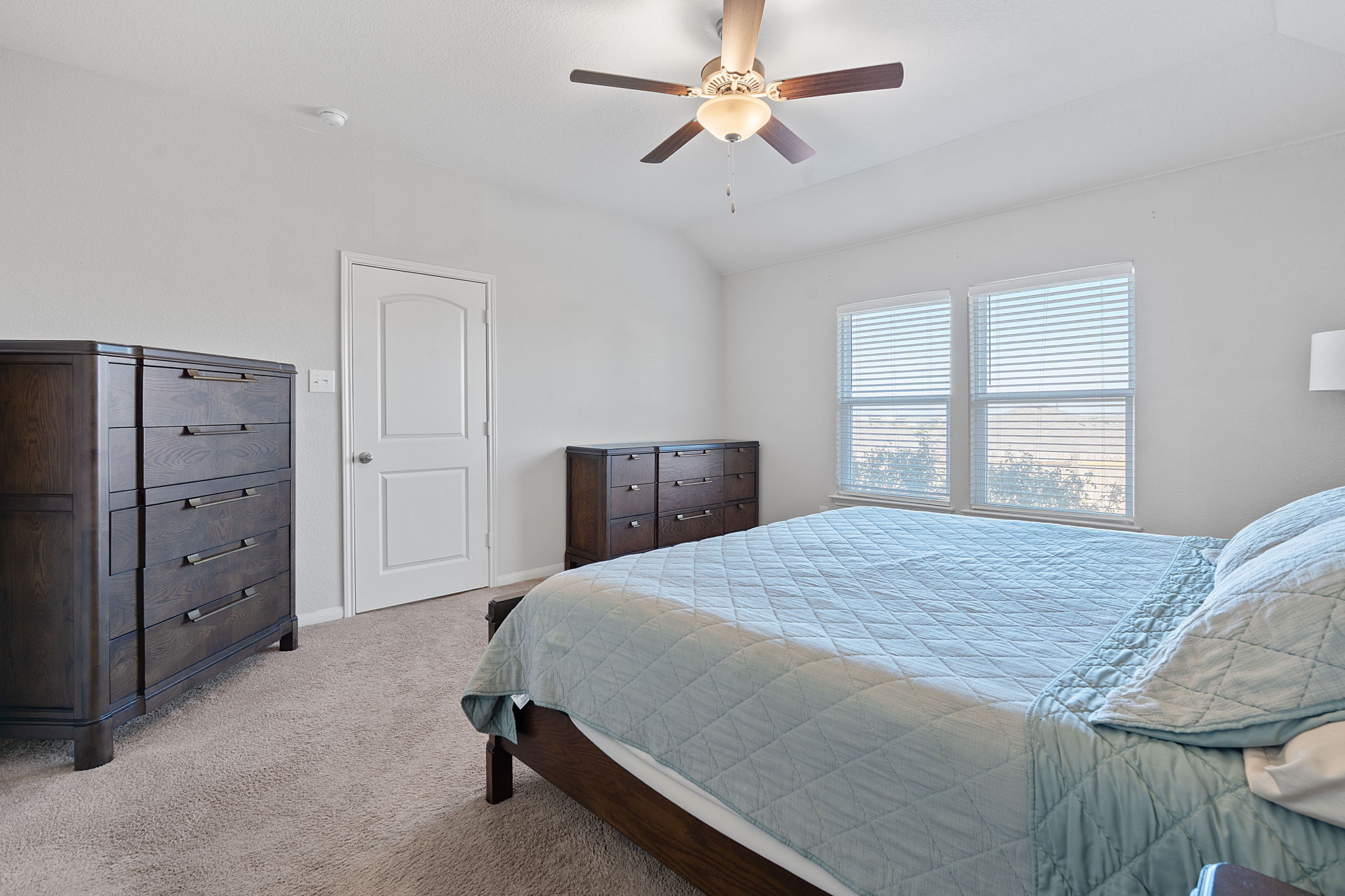 19212 Andrew Jackson Street Manor, TX 78653 - Photo 15 of 35 a bedroom with a bed and a dresser