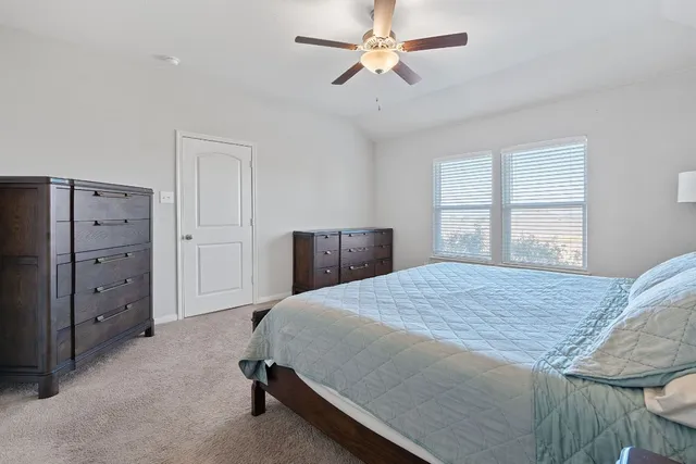 a white bath tub sitting next to a white sink and a shower