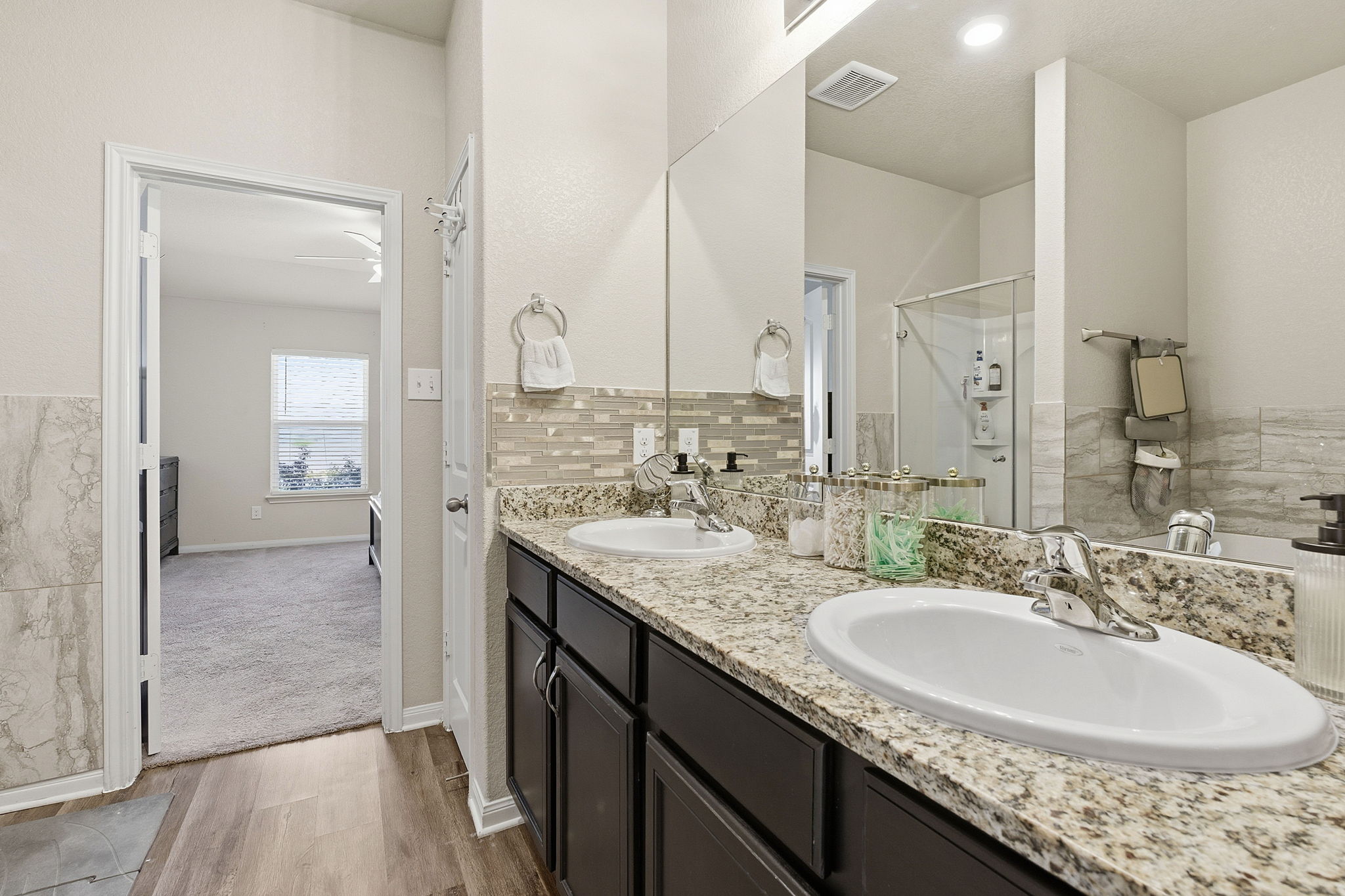 19212 Andrew Jackson Street Manor, TX 78653 - Photo 17 of 35 a bathroom with a granite countertop sink and a mirror