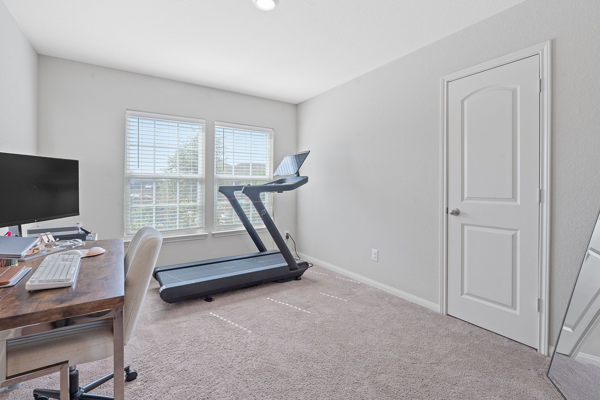 19212 Andrew Jackson Street Manor, TX 78653 - Photo 19 of 35 a room with gym equipment and a flat screen tv