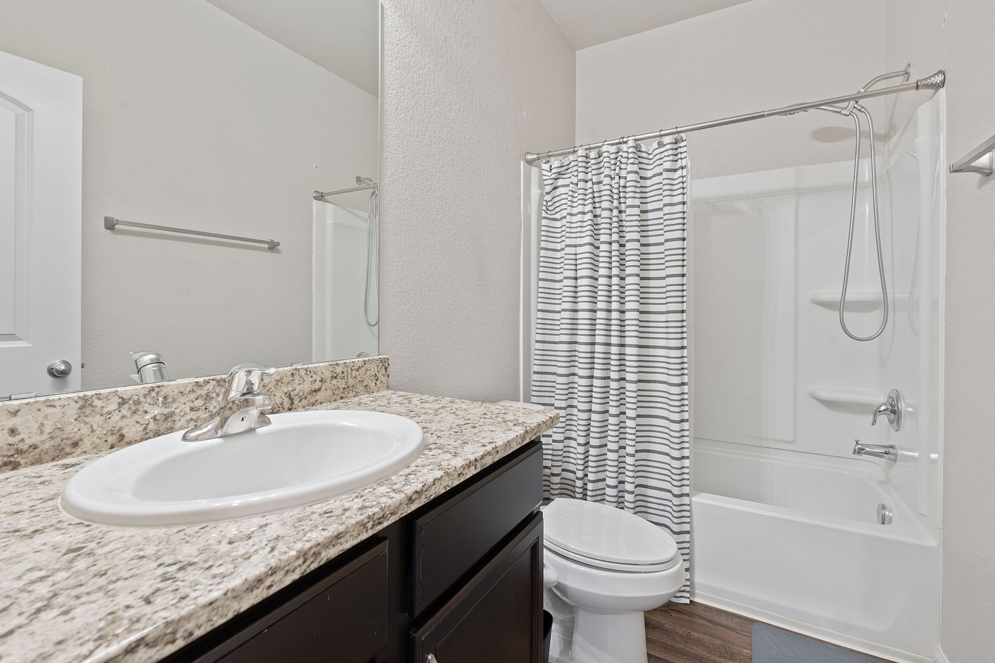 19212 Andrew Jackson Street Manor, TX 78653 - Photo 20 of 35 a bathroom with a granite countertop sink toilet and shower