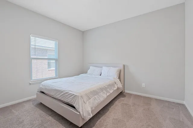 a bedroom with a bed and window