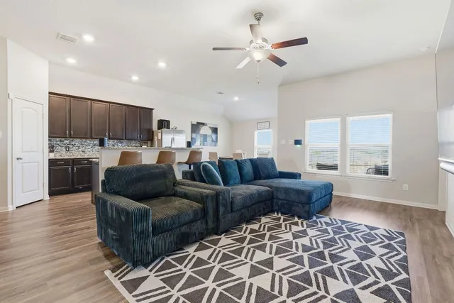 a kitchen with kitchen island granite countertop a stove top oven microwave and refrigerator