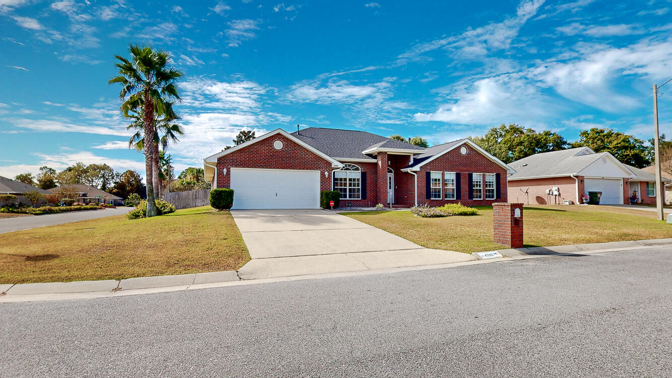 4787 Ribault Lane Milton, FL 32570 - Photo 1 of 36 a front view of a house with a yard