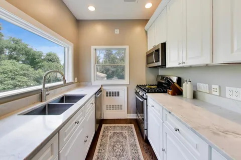 a kitchen that has a sink and a stove