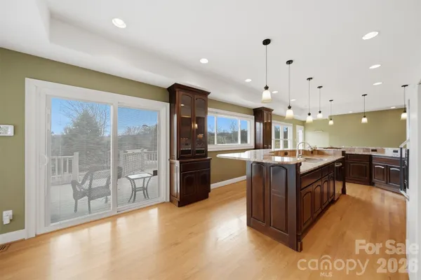 a kitchen with stainless steel appliances granite countertop a refrigerator a sink and a stove