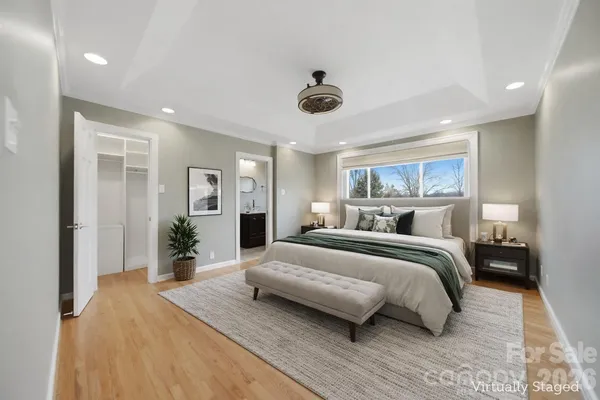 a bedroom with a large bed and a chandelier