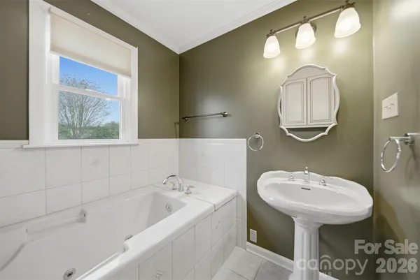 a bathroom with a sink a mirror and a bathtub