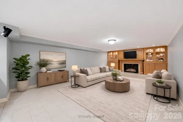 a living room with furniture a fireplace and a potted plant
