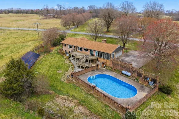 a swimming pool with outdoor seating and yard
