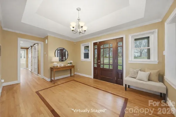 a living room with furniture and a chandelier