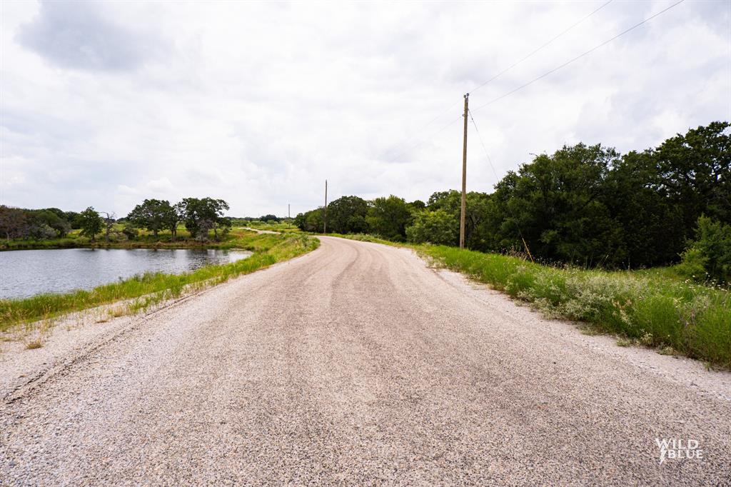 2170 River Shls Road Mineral Wells, TX 76067 - Photo 29 of 40 a view of a road with a big yard and a large building