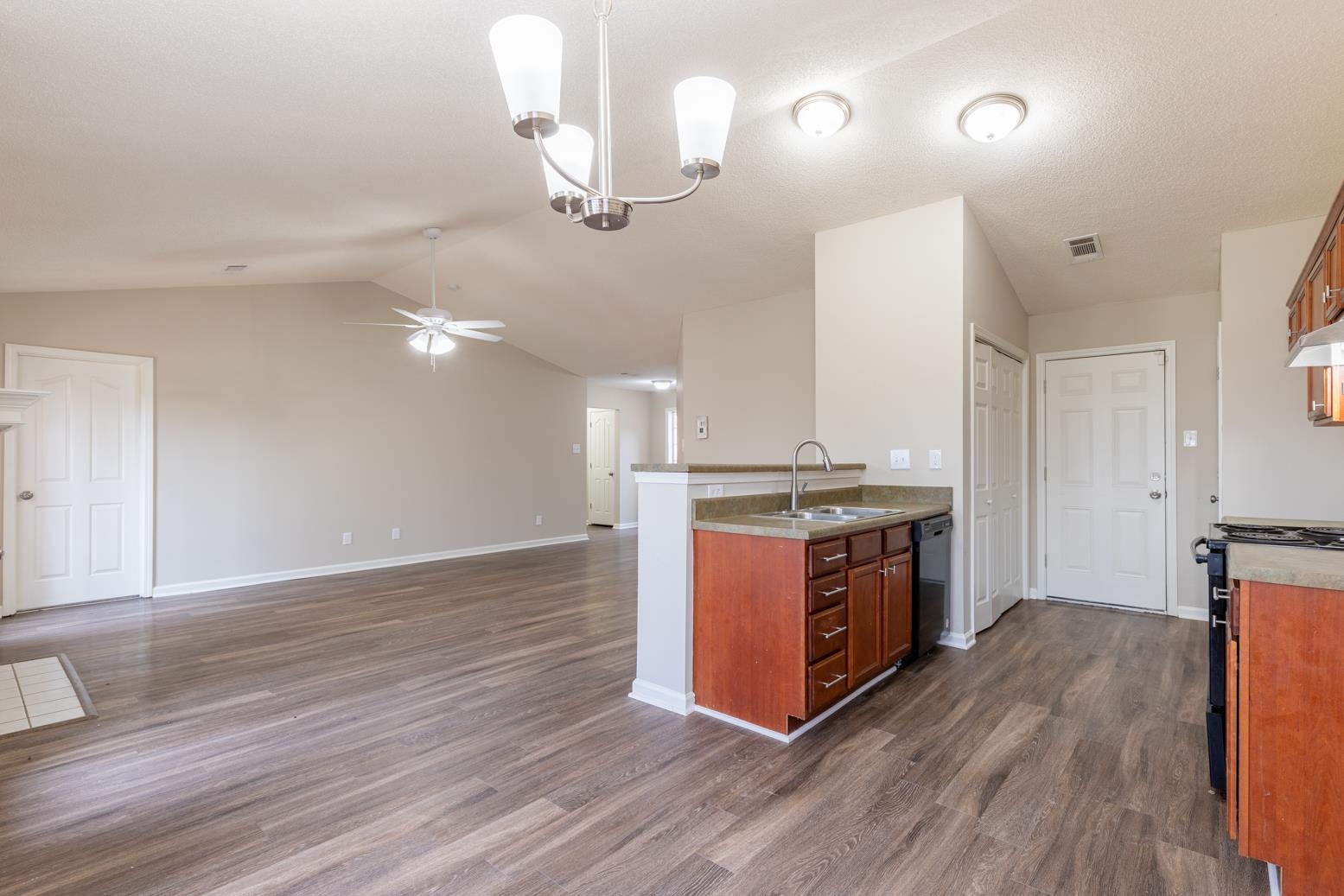 4185 Hampton Manor Lane Memphis, TN 38128 - Photo 12 of 20 a kitchen with stainless steel appliances granite countertop a wooden cabinets a stove a sink and a wooden floors