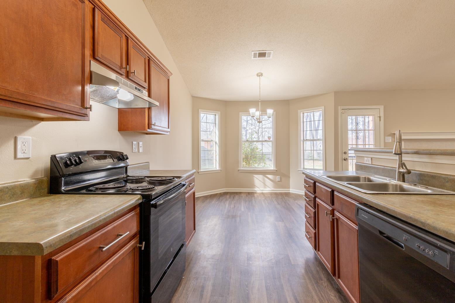 4185 Hampton Manor Lane Memphis, TN 38128 - Photo 15 of 20 a kitchen with stainless steel appliances granite countertop a stove a sink and a refrigerator