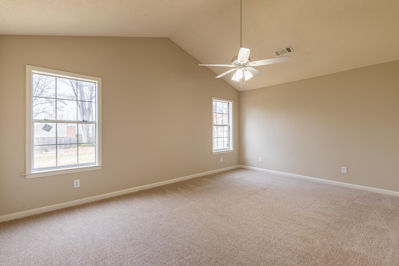 4185 Hampton Manor Lane Memphis, TN 38128 - Photo 16 of 20 an empty room with windows and fan chandelier fan
