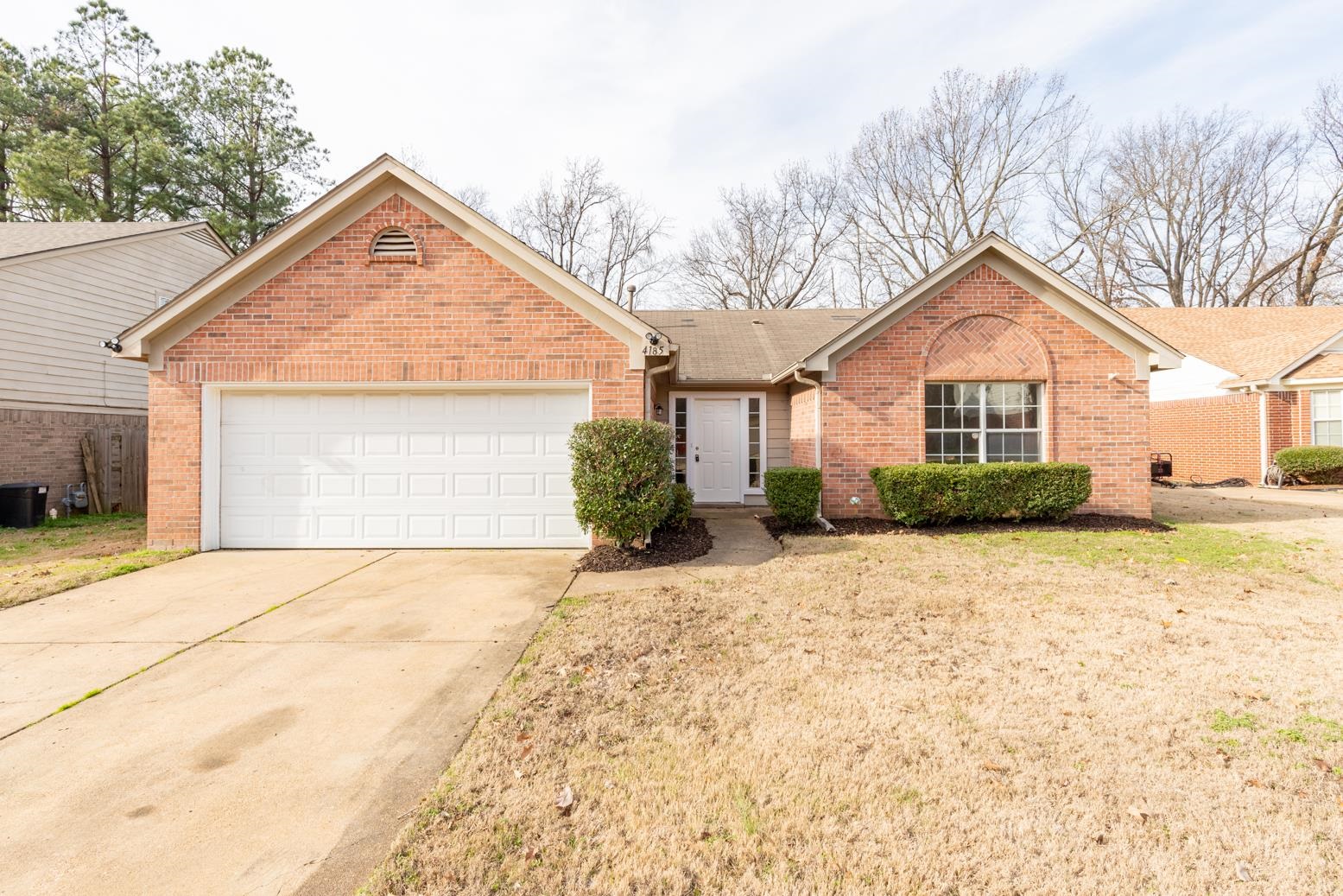 4185 Hampton Manor Lane Memphis, TN 38128 - Photo 2 of 20 a front view of a house with a yard and garage