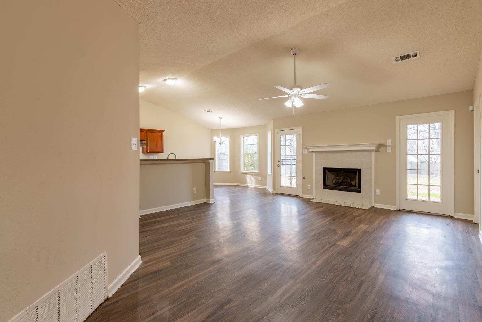 4185 Hampton Manor Lane Memphis, TN 38128 - Photo 7 of 20 a view of a livingroom with wooden floor and a kitchen