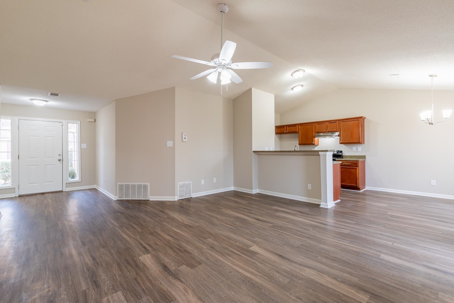 4185 Hampton Manor Lane Memphis, TN 38128 - Photo 8 of 20 wooden floor in an empty room with a kitchen
