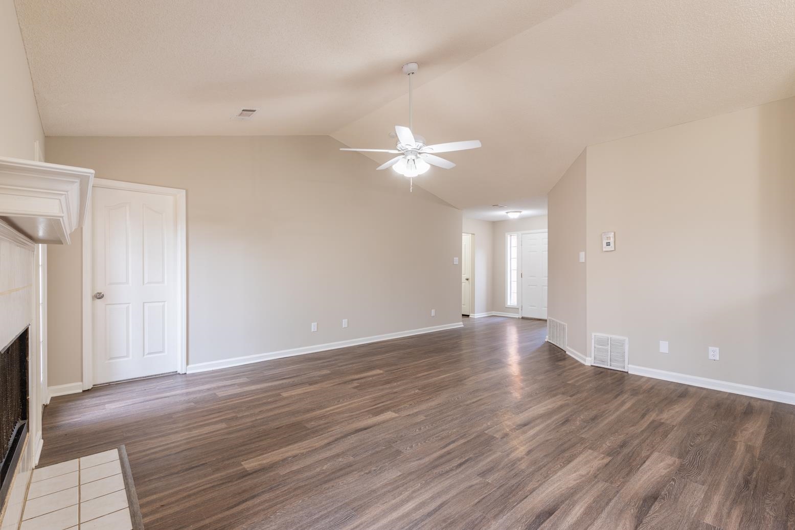 4185 Hampton Manor Lane Memphis, TN 38128 - Photo 9 of 20 a view of an empty room with wooden floor and a window