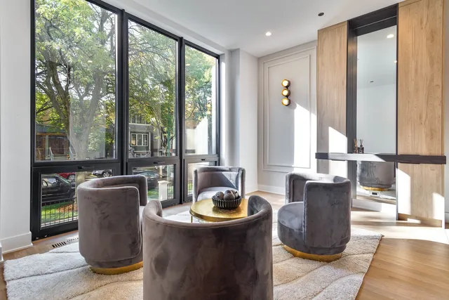 a living room with furniture and large windows