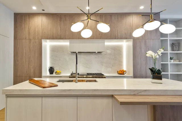 a kitchen with a sink and a large mirror