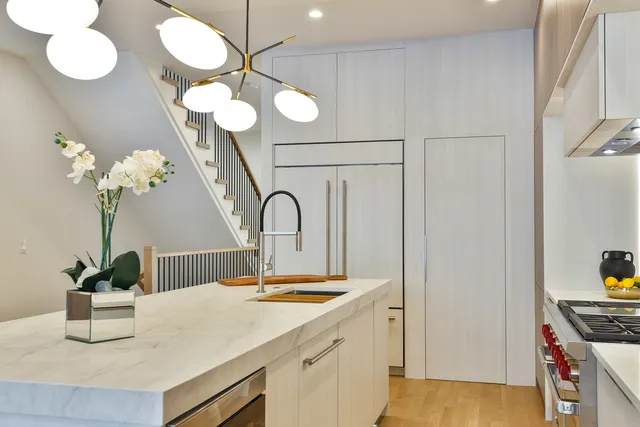 a kitchen with a sink and a chandelier