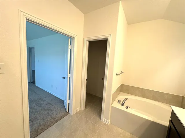 a bathroom with a tub a sink and a shower