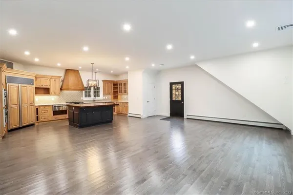 a view of a kitchen with furniture and wooden floor
